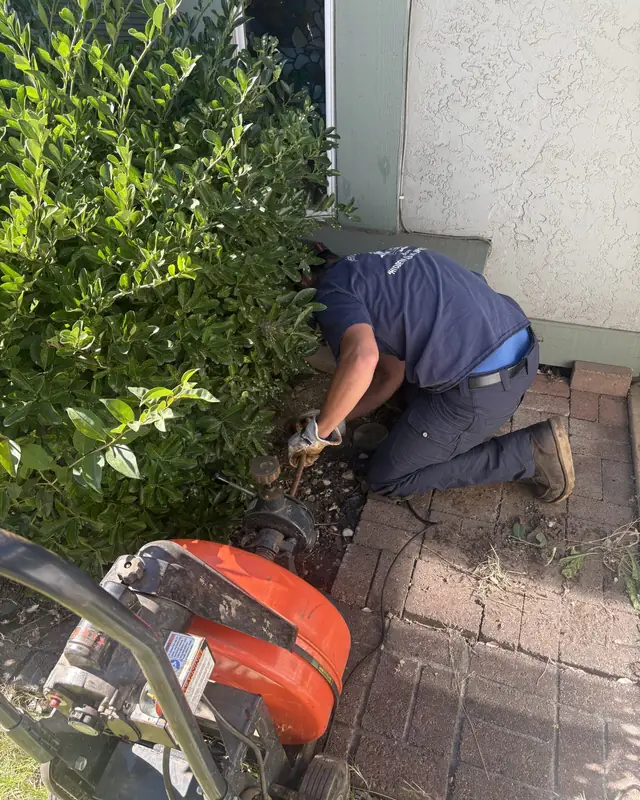 Jeff's Plumbing technician working at an outdoor cleanout