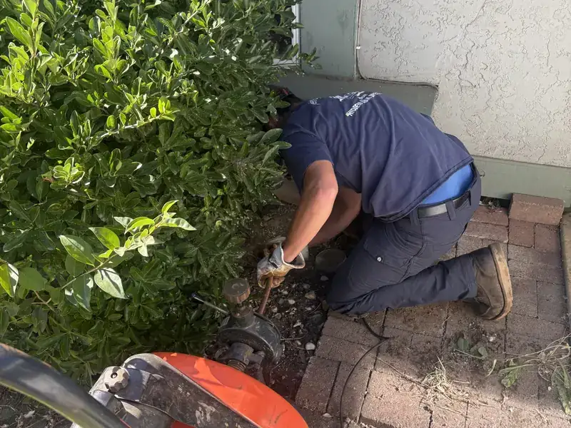Jeff's Plumbing technician working at an outdoor cleanout